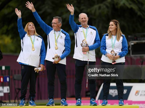 Gold medalists Melanie Inness, George Miller, Robert Barr and Sarah Jane Ewing of Team Scotland pose on the podium during Para Mixed Pairs B2/B3 -...