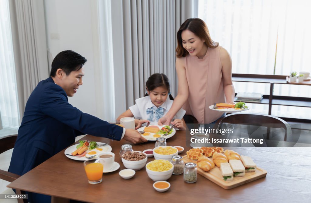 Happy family having breakfast at home