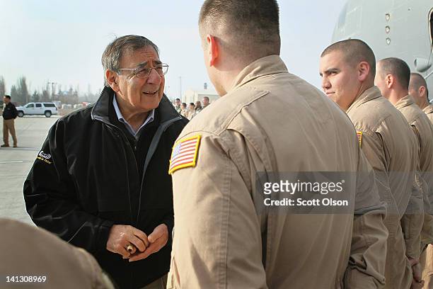 Secretary of Defense Leon Panetta greets his flight crew as he prepares to depart from the Transit Center at Manas to Camp Leatherneck in Afghanistan...