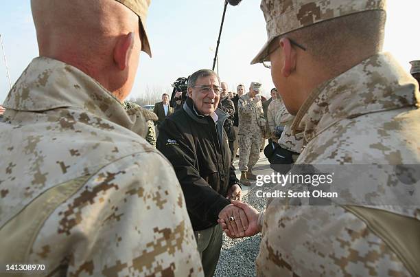 Secretary of Defense Leon Panetta greets Marines flying from Afghanistan as they pass through the Transit Center at Manas back to their home duty...