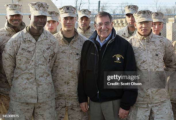 Secretary of Defense Leon Panetta poses for a picture with Marines flying from Afghanistan as they pass through the Transit Center at Manas back to...