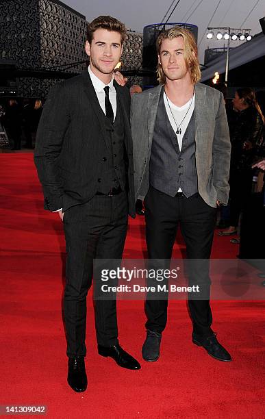 Actors Liam Hemsworth and Chris Hemsworth arrive at the European Premiere of 'The Hunger Games' at the O2 Arena on March 14, 2012 in London, England.