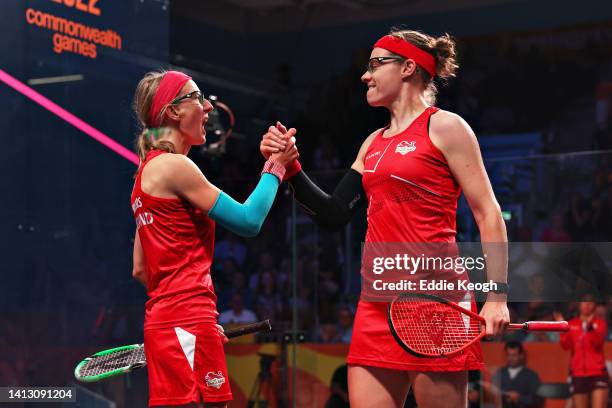 Sarah-Jane Perry and Alison Waters of Team England celebrate winning during their Squash Women's Doubles Quarter-Final match against Lisa Aitken and...