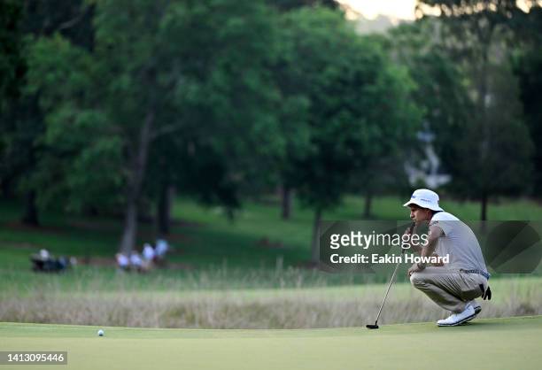 Peter Malnati of the United States lines up a putt on the first green during the second round of the Wyndham Championship at Sedgefield Country Club...