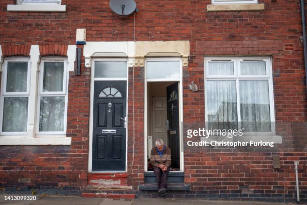 Man sits on his door step on August 05, 2022 in Stoke-on-Trent United Kingdom. The city of Stoke-on-Trent was one of the fastest local economies to...
