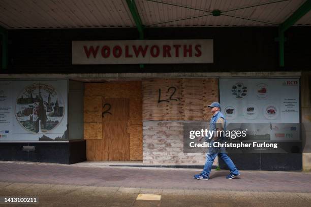 Shopper walks past the closed down Woolworths store in Longton on August 05, 2022 in Stoke-on-Trent United Kingdom. The city of Stoke-on-Trent was...