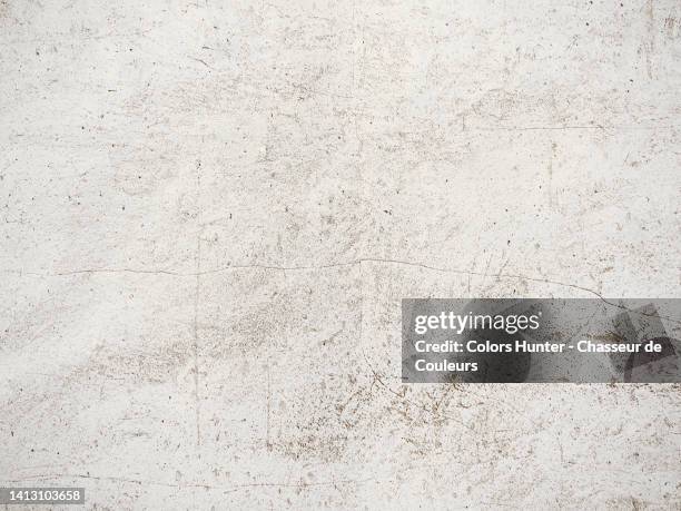 weathered and scratched white paint on a stone wall in paris, france - stone material stockfoto's en -beelden