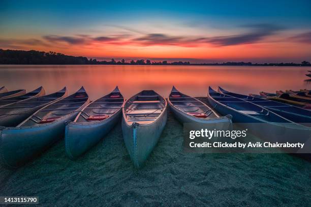 sunset over creve couer lake with boats in foreground in creve couer, missouri, usa - missouri stock pictures, royalty-free photos & images