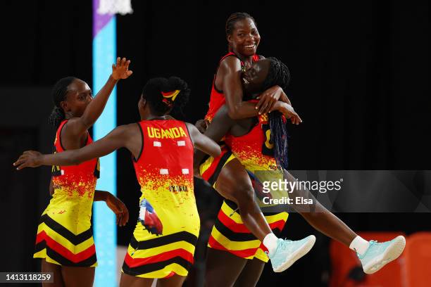 Shadiah Nassanga and Mary Cholhok of Team Uganda celebrate their victory in Netball - Classification 5-6 match between South Africa and Uganda on day...