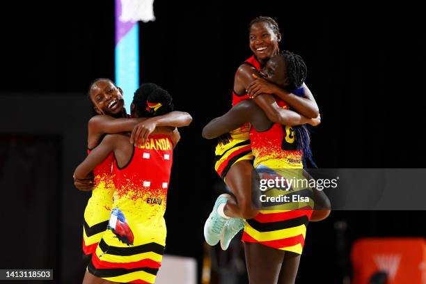 Shaffie Nalwanja, Irene Eyaru, Shadiah Nassanga and Mary Cholhok of Team Uganda celebrate their victory in Netball - Classification 5-6 match between...