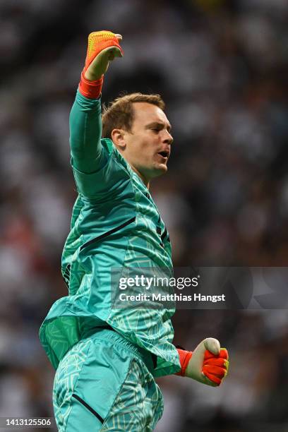 Manuel Neuer of Bayern Munich celebrates after Serge Gnabry of Bayern Munich scores their side's fifth goal during the Bundesliga match between...