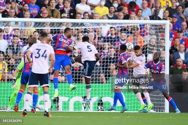 Gabriel Martinelli of Arsenal scores their side's first goal whilst under pressure from Michael Olise and Odsonne Edouard of Crystal Palace during...