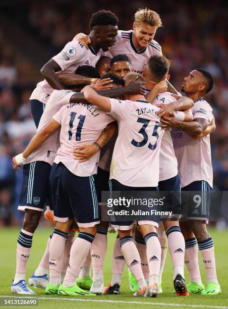 Gabriel Martinelli of Arsenal celebrates scoring their side's first goal with teammates during the Premier League match between Crystal Palace and...