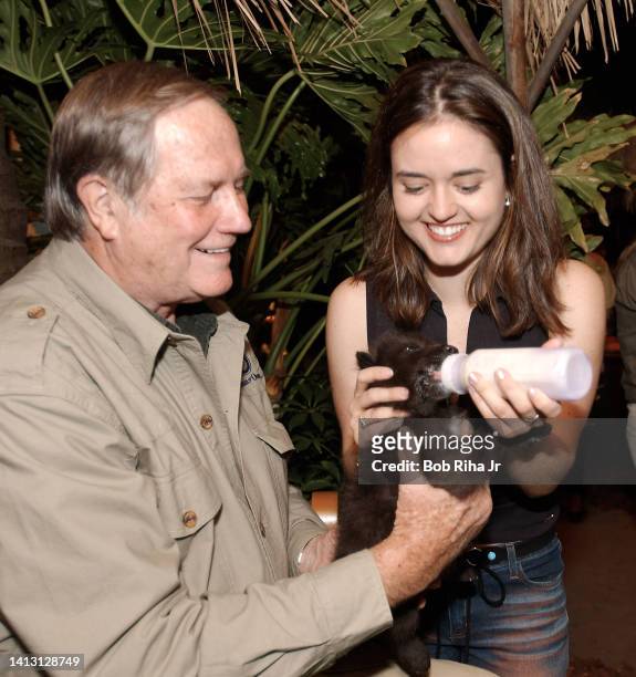 Mutual of Omaha's Jim Fowler helps Actress Danica McKellar feed a 3-week-old wolf pup at the Wild Kingdom Kids' Summit on Conservation, May 7, 2002...