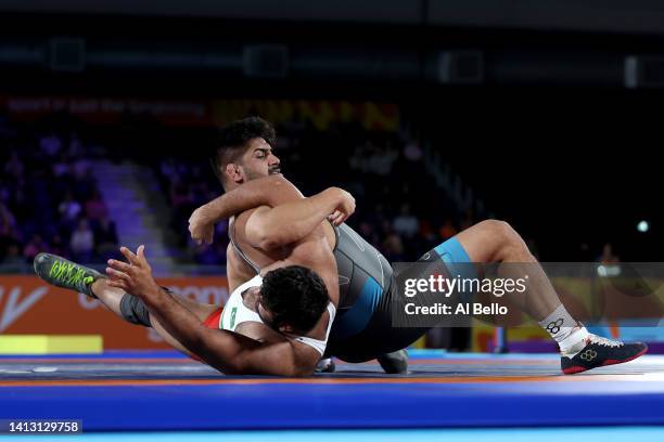 Amarveer Dhesi of Team Canada competes against Zaman Anwar of Team Pakistan during the Men's Freestyle Wrestling 125 kg Gold Medal on day eight of...