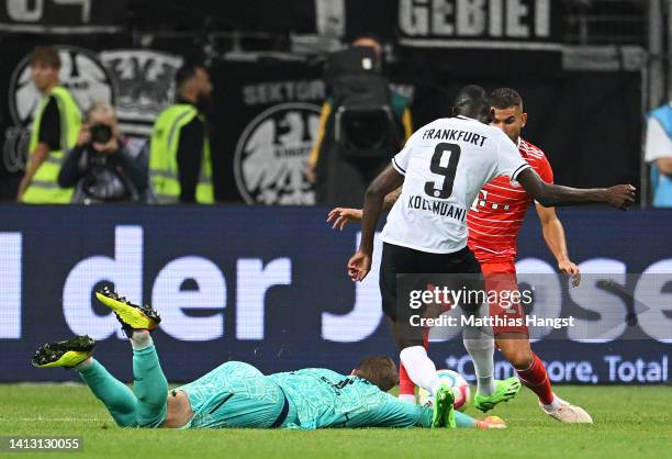 Manuel Neuer of Bayern Munich looks on as Randal Kolo Muani of Eintracht Frankfurt scores their side's first goal whilst under pressure from Lucas...