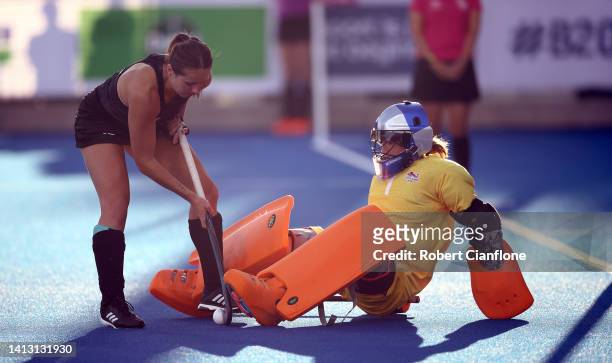 Madeleine Hinch of Team England saves a penalty in the penalty shoot out from Olivia Shannon of New Zealand during the Women 's Hockey Semi-Final...