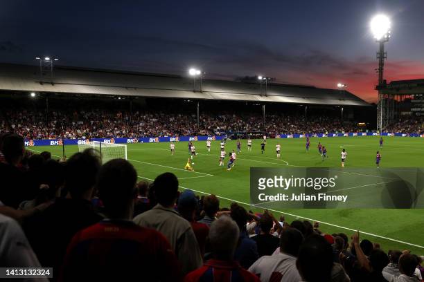 General view as the Sunsets behind Selhurst Park as Aaron Ramsdale of Arsenal saves a shot from Eberechi Eze of Crystal Palace during the Premier...