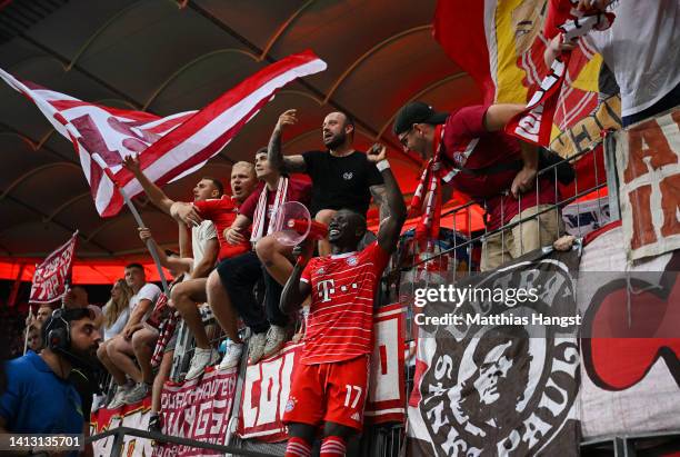 Sadio Mane of Bayern Munich, using a Megaphone, celebrates with fans after the final whistle of the Bundesliga match between Eintracht Frankfurt and...