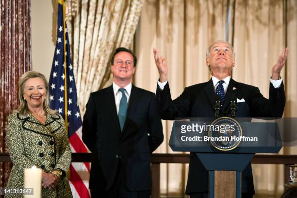 Secretary of State Hillary Clinton and British Prime Minister David Cameron laugh as Vice President Joe Biden makes a joke about asking his Irish...