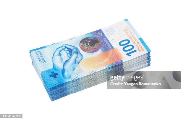 stack of 100 swiss francs banknotes on white background - franc symbol stock-fotos und bilder