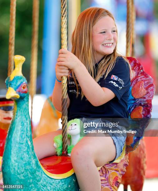 Mia Tindall rides on a carousel as she attends day 1 of the 2022 Festival of British Eventing at Gatcombe Park on August 5, 2022 in Stroud, England.
