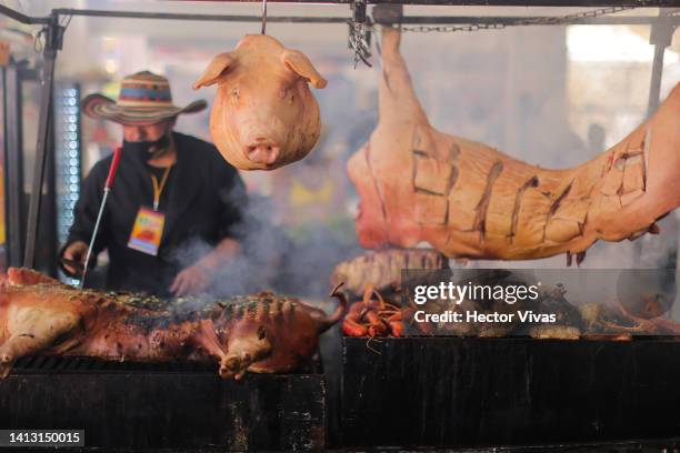 Pig is cooked over charcoal to be used in the preparation of traditional Colombian sandwiches called Arepas during the 17th edition of Mexico's...