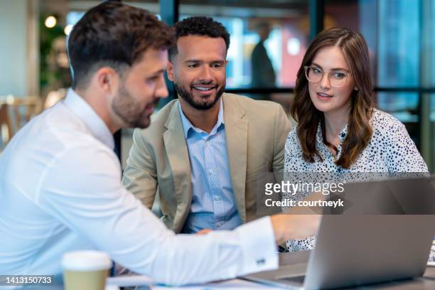 financial advisor or lawyer with couple explaining options. - bankers stock pictures, royalty-free photos & images