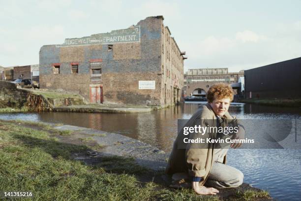 Mick Hucknall, lead singer of British band Simply Red, by a canal in Manchester, 1985.