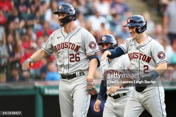 Trey Mancini of the Houston Astros celebrates with Alex Bregman and Jose Altuve after Mancini hit a grand slam in the top of the third inning during...