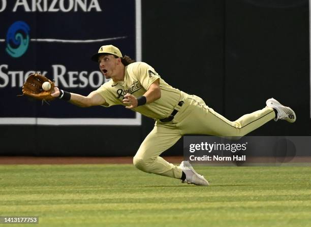 Jake McCarthy of the Arizona Diamondbacks attempts to make a diving catch on a fly ball hit by Elehuris Montero of the Colorado Rockies during the...