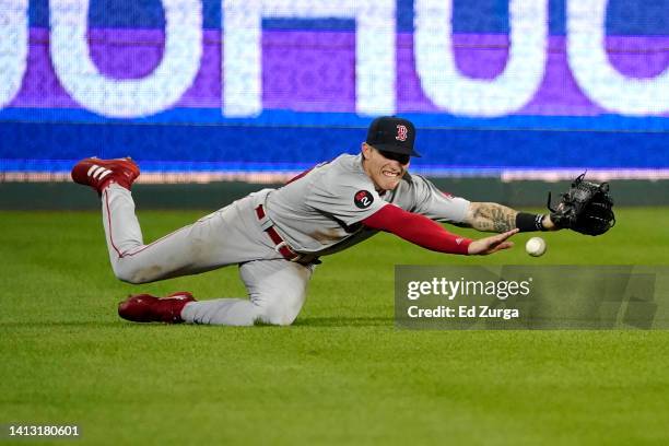 Jarren Duran of the Boston Red Sox dives but can't catch a ball hit by Michael A. Taylor of the Kansas City Royals in the eighth inning at Kauffman...