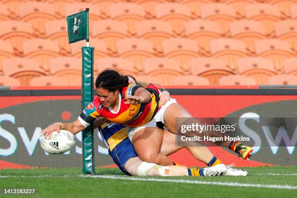 Cheyelle Robins-Reti of Waikato scores a try in the tackle of Olive Watherston of Bay of Plenty during the round four Farah Palmer Cup match between...