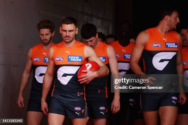 Stephen Coniglio of the Giants and Josh Kelly of the Giants lead team mates onto the field during the round 21 AFL match between the Greater Western...