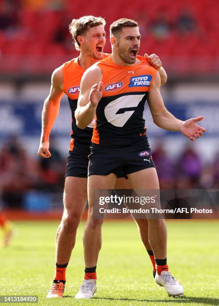 Stephen Coniglio of the Giants celebrates kicking a goal during the round 21 AFL match between the Greater Western Sydney Giants and the Essendon...