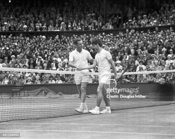 Australian tennis player Martin Mulligan shakes hands with fellow Australian Rod Laver, who has just defeated him in the finals of the men's singles...