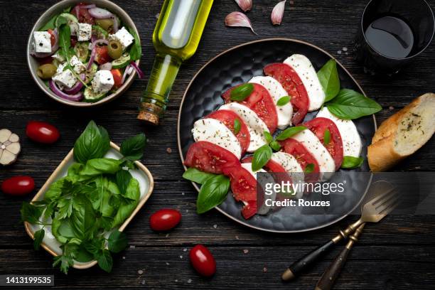 verity of italian dish - caprese salad stock pictures, royalty-free photos & images