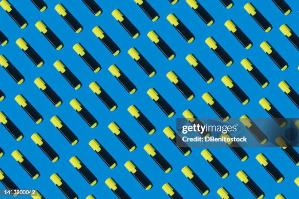 pattern of yellow highlighter pens on blue background. concept of college, university, study, underline, work, fluorescent and highlight. - highlighter stock pictures, royalty-free photos & images