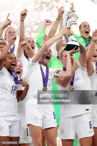 Leah Williamson and Millie Bright of England lift the trophy after their teams victory during the UEFA Women's Euro 2022 final match between England...