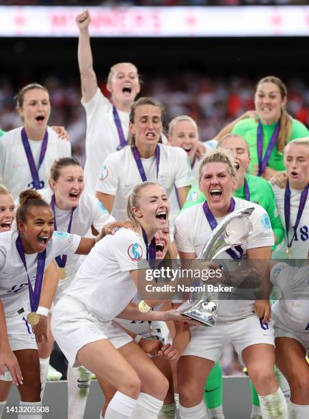 Leah Williamson and Millie Bright of England lift the trophy after their teams victory during the UEFA Women's Euro 2022 final match between England...