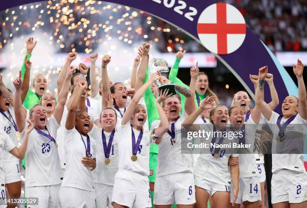 Leah Williamson and Millie Bright of England lift the trophy after their teams victory during the UEFA Women's Euro 2022 final match between England...