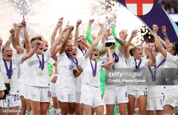 Leah Williamson and Millie Bright of England lift the trophy after their teams victory during the UEFA Women's Euro 2022 final match between England...