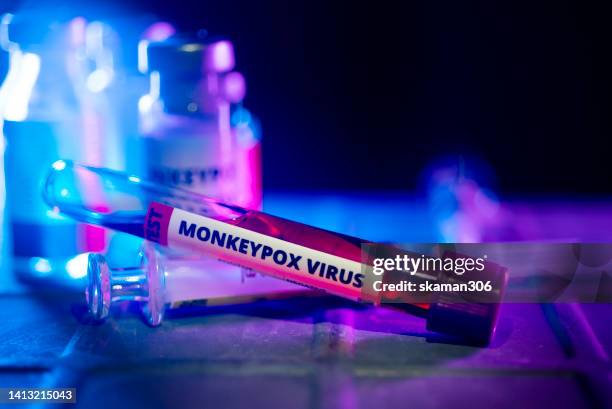 close up laboratory blood tube of infected new strain monkeypox virus with vaccination vaccine and injection needle - poxvirus imagens e fotografias de stock