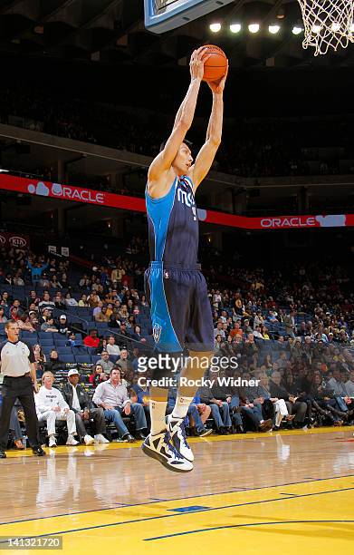 Yi Jianlian of the Dallas Mavericks grabs the rebound against the Golden State Warriors on March 10, 2012 at Oracle Arena in Oakland, California....