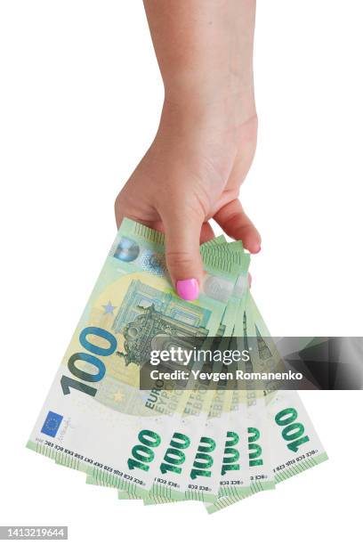 woman's hand giving 100 euro bills, isolated on white background - european union euro note stock pictures, royalty-free photos & images