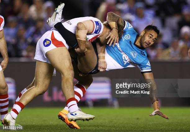 Briton Nikora of the Sharks is tackled by Jack de Belin of the Dragons during the round 21 NRL match between the Cronulla Sharks and the St George...