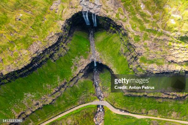 aerial view of the fossa waterfall at sunset. faroe islands, denmark - faroe islands photos et images de collection