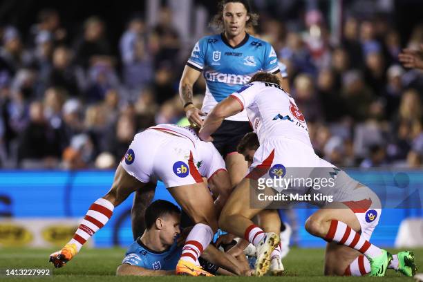 Connor Tracey of the Sharks is hit high in a tackle by Tariq Sims of the Dragons during the round 21 NRL match between the Cronulla Sharks and the St...