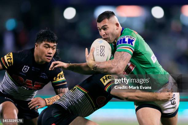 Nick Cotric of the Raiders is tackled by Brian To'o of the Panthers during the round 21 NRL match between the Canberra Raiders and the Penrith...