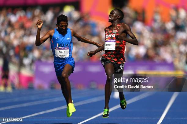 Abraham Kibiwot of Team Kenya crosses the finish line to claim the gold medal ahead of silver medalist Avinash Mukund Sable of Team India during the...
